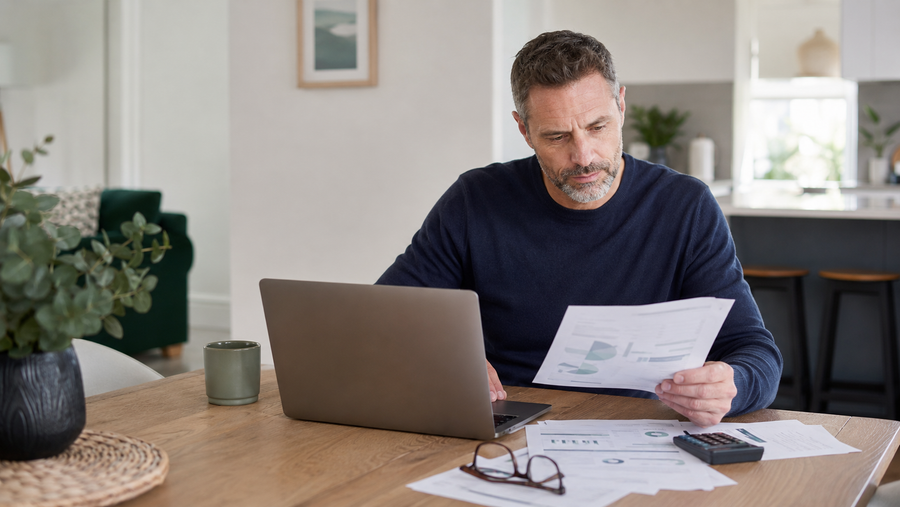 Australian worker reviewing superannuation fees on annual statements at home