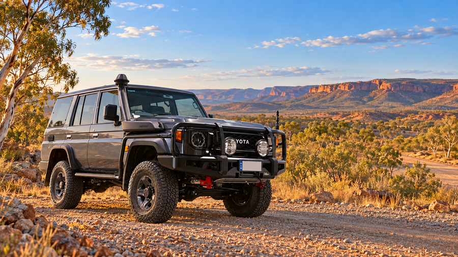 Illustration of a grey Toyota LandCruiser 76 Series GXL beside an Australian outback track, with eucalyptus scrub and distant ochre escarpments.